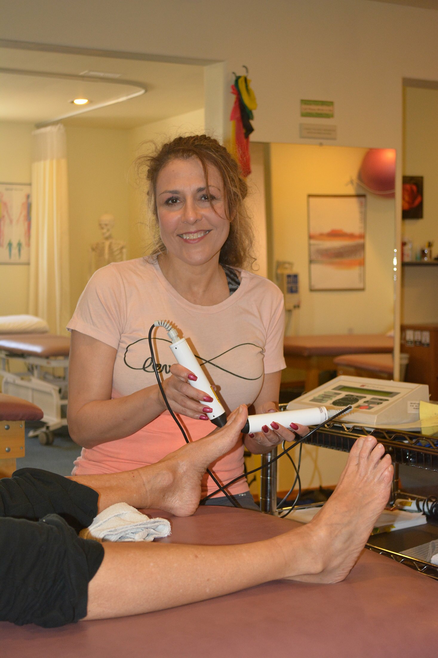 Lisa using laser treatment on a patient